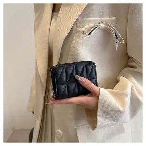 Detailed view of a chic black quilted card holder wallet, featuring a secure zipper closure.