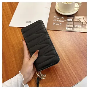 Black quilted long wallet for women, stylish zip-around purse with chic clover charm.