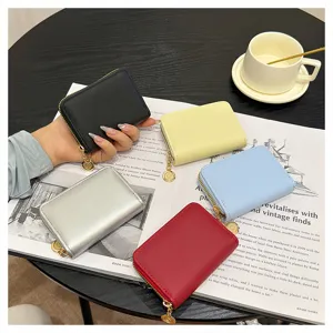 Detail view of multi-color zipper card wallet set, featuring compact design and metallic charms.