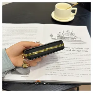 Close-up of black quilted card holder zipper detail, elegant women accessory showcasing texture.