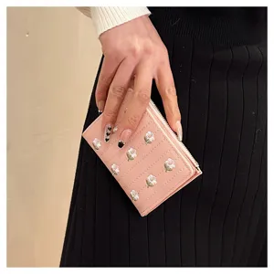 Women's short pink wallet with cute floral embroidery, folding zipper coin purse design.