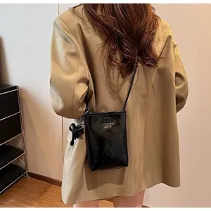 Stylish mini cross body phone bag for women with cute elephant pendant, black PU leather.