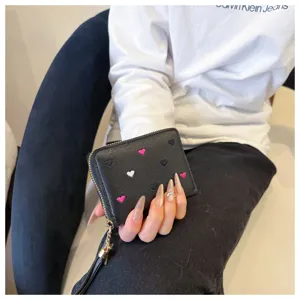 Short black PU leather wallet with cute embroidered hearts and zipper coin purse design.