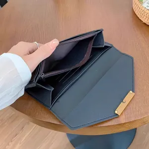 Black women's long wallet with multiple card slots, slim folding design, and stylish metal clasp.