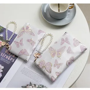 Exquisite butterfly embroidered women wallet detail featuring elegant pearl wrist strap zipper pouch.