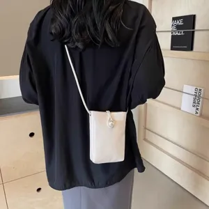 Chic women's crossbody phone bag with elegant pearl closure, lightweight summer shoulder bag.