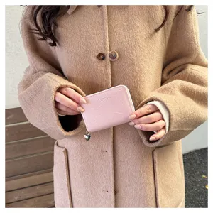 Pink zipper card holder for women with cute heart pendant, compact and multi-slot wallet.