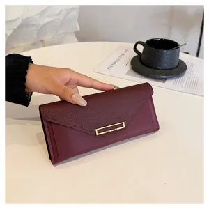 Elegant long women wallet with envelope flap design, multiple card slots and stylish metal decor.