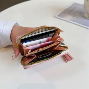 Pink PU leather short wallet for women, cute coin purse with card slots and tassel.