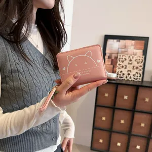 Pink short wallet for women with cute cat ears print, zipper closure and stylish tassel pendant.