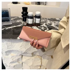 Detailed shot of a chic color-blocked long wallet in pink and brown with a sleek metal clasp.