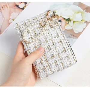 Chic tweed wallet card holder with pearl chain and metal pendant, elegant design for women.