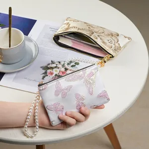 Chinese style embroidered pearl handle coin purse and phone clutch bag main view display.