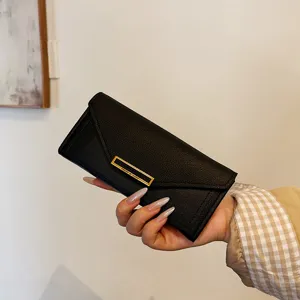 Elegant women long black wallet envelope style PU leather clutch purse with gold metal accent.