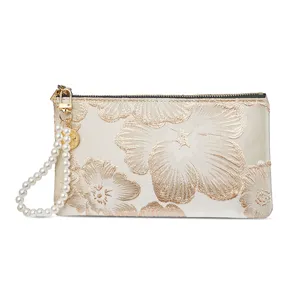 Elegant Chinese style embroidered clutch bag with pearl wrist strap, zipper closure, gold floral.