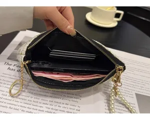 Small tweed zipper coin purse with pearl wrist strap, card slots and phone storage detail.