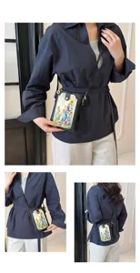 Detail shot of women crossbody phone bag with cute sunflower illustration and slim shoulder strap.
