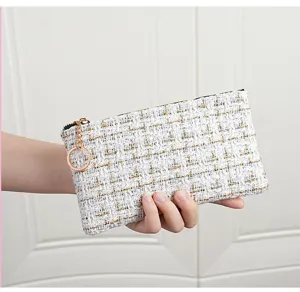 White tweed coin purse featuring gold threads, smooth zipper closure, and practical keyring.