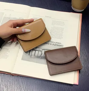 Detailed shot of minimalist PU leather card holder wallet in brown, sleek flap closure design.
