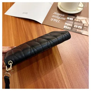 Black quilted long wallet detail, PU leather clutch purse with gold zipper and wrist strap.
