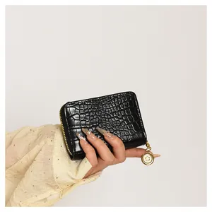 Black crocodile embossed zipper card holder with gold hardware and coin purse detail.
