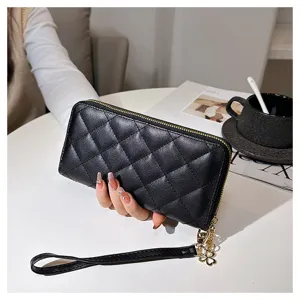 Black quilted long wallet for women, featuring a secure zip-around closure and convenient wrist strap.