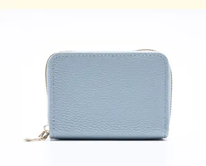Gros plan detaille du porte-cartes bleu clair avec poche zippee et finition cuir texture.