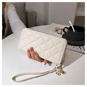 Quilted long wallet for women, featuring zip closure, wrist strap, and metal charm.