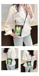 Detail view of a cute anime print crossbody phone bag worn by a model, small and stylish.