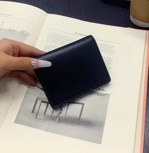 Minimalist solid color PU leather short card holder and coin purse, compact and portable design.