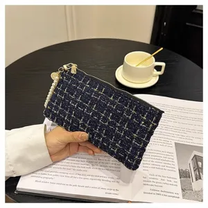 Women tweed short wallet clutch bag with pearl strap and zipper closure, detail view.