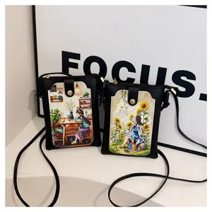 Close-up of black crossbody phone bag with artistic girl illustration and shoulder strap.