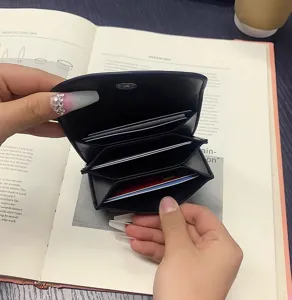 Detailed view of a minimalist black PU leather card wallet with multiple slots.