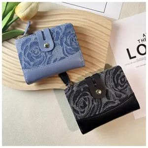 Detailed view of women denim short wallet with rose pattern, zipper and snap button closure.
