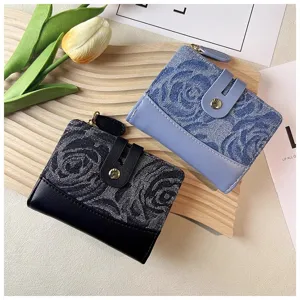 Detail shot of stylish denim short wallet with floral pattern, multi-card slots and snap closure.