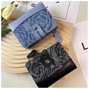 Close-up of women short wallet, stylish denim floral pattern, card slots and metal zipper pocket.
