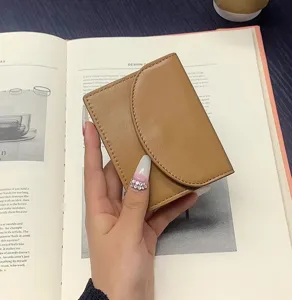 Minimalist brown PU leather card holder, compact short coin purse for daily use and travel.