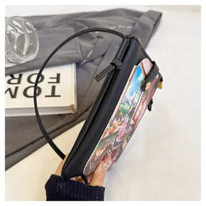 Black leather crossbody phone bag with cute anime illustration pocket, slim strap and zipper.
