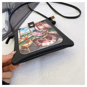 Detail shot of black PU crossbody phone bag with anime illustration flap and slim shoulder strap.