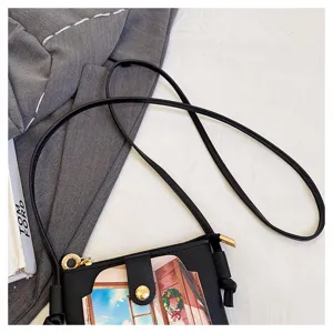 Women black crossbody phone bag detail view, small shoulder bag with zipper and front snap pocket.