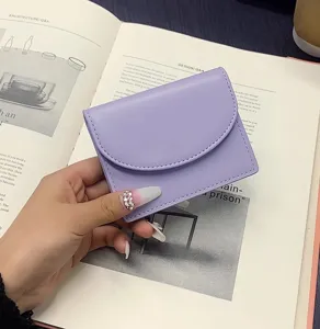 Detail view of a simple solid color purple PU leather card holder and mini coin purse.