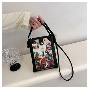 Black crossbody phone bag detail showing cute girl illustration pocket and secure zipper design.