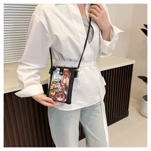 Detailed view of women crossbody phone bag with cute anime print and slim shoulder strap.