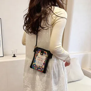Mini black crossbody phone bag with colorful printed front flap, chic and cute daily shoulder bag.