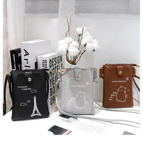 Detail view of mini PU leather crossbody phone bags in black, grey and brown with cute prints.
