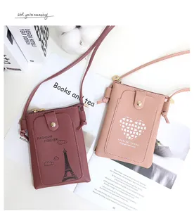 Detail view of mini PU leather crossbody phone bag with front pocket and delicate strap design.