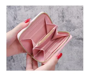 Pink short zipper wallet detail view featuring multiple card slots, coin pouch and compartments.