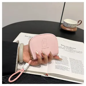 Pink mini coin purse with card slot and cute cartoon print, portable wallet for women.