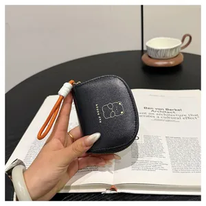 Black mini coin purse with cute cartoon bear print and orange lanyard for daily use.