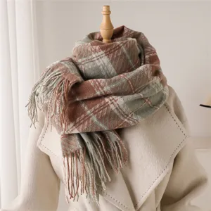 Detail view of cozy autumn winter plaid fringe scarf showing texture and warm brown green tones
